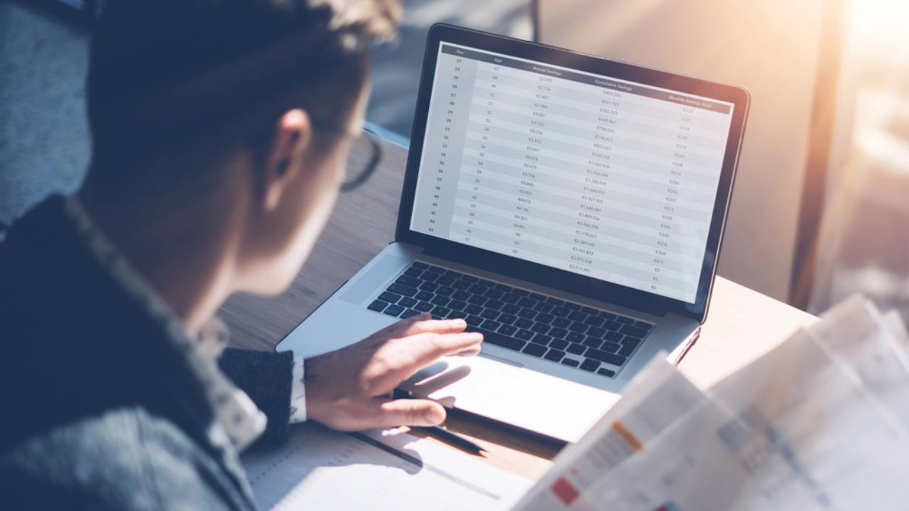 man at his computer spreadsheets work