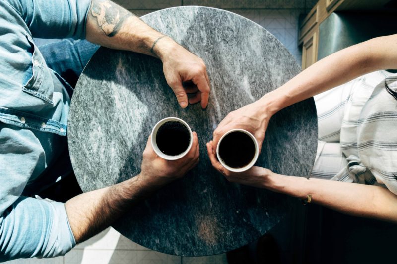 people drinking coffee at a table