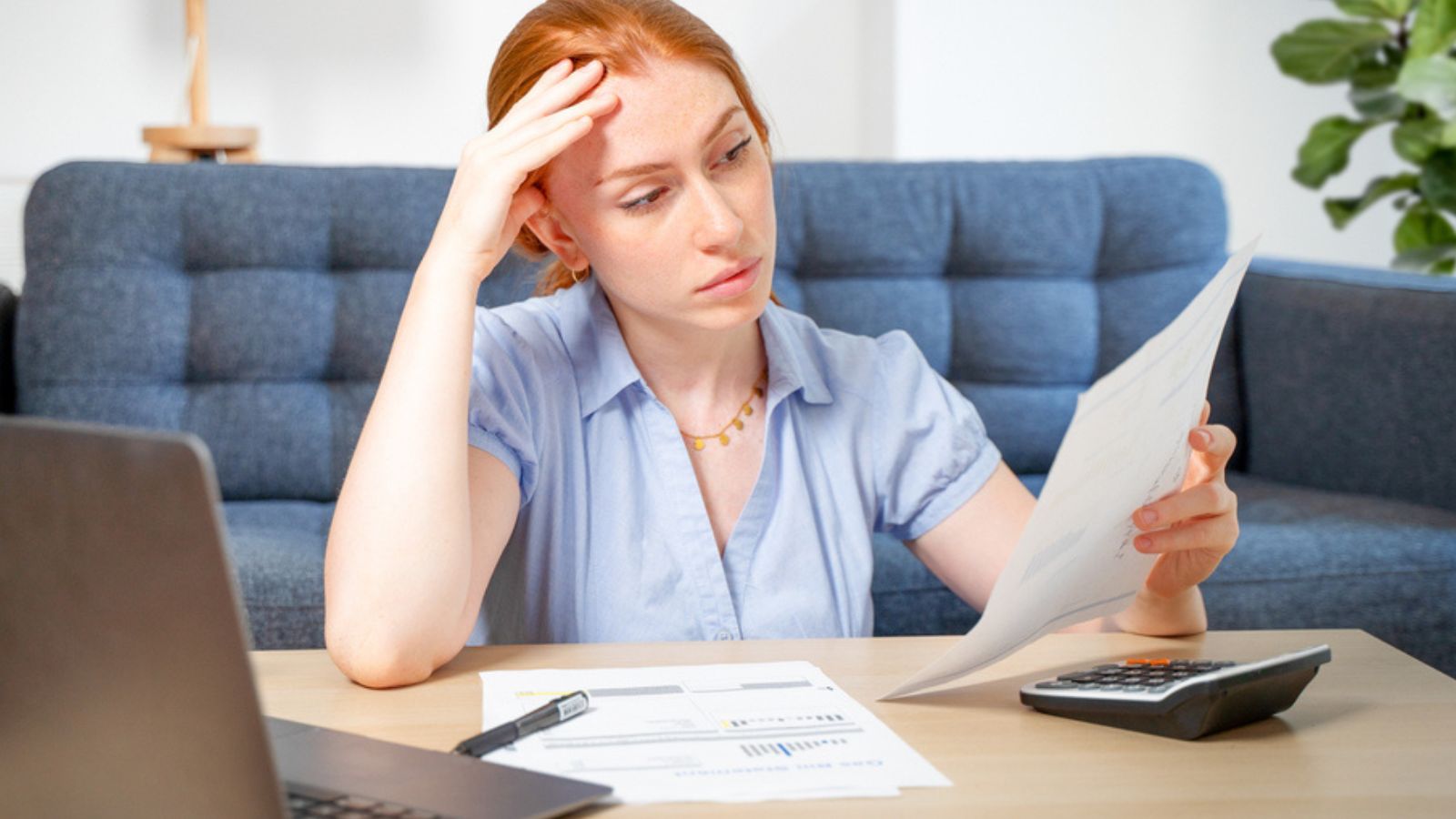 Woman working through papers and calculating home budget