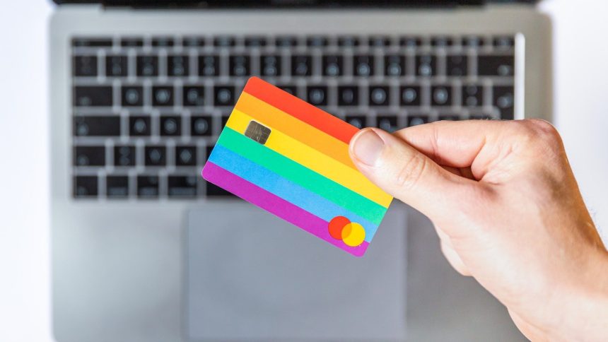 person holding yellow and pink card; Person reviewing credit card balances on a laptop to calculate; credit utilization ratio