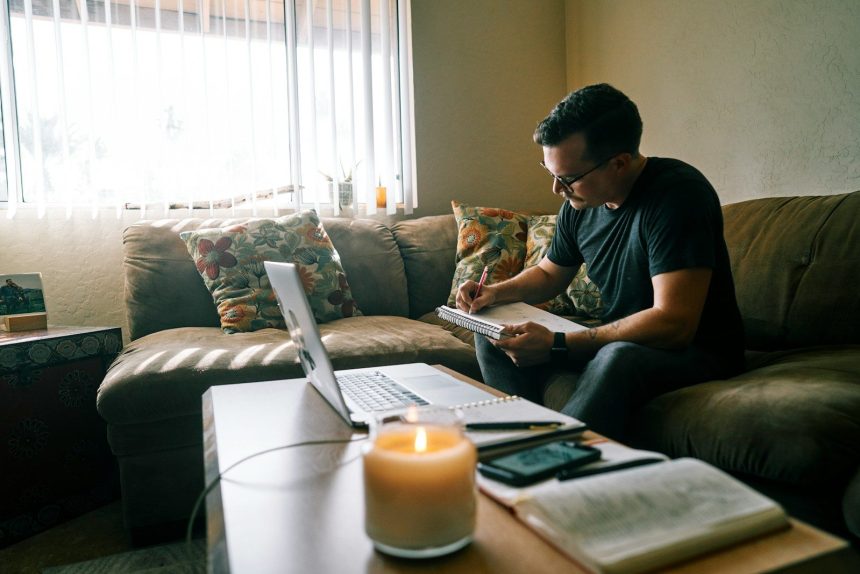 man in black crew neck t-shirt sitting on couch; debt avalanche method