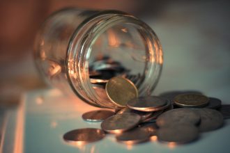 clear glass jar with coins; emergency fund