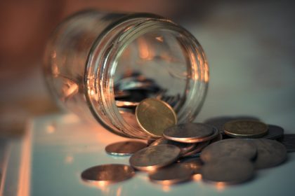 clear glass jar with coins; emergency fund