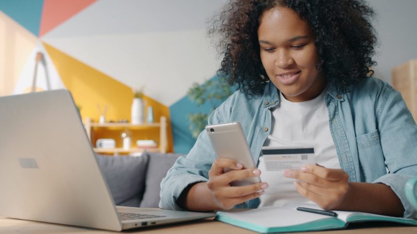 Teenager using phone and credit card for online shopping; automate debt payments