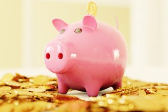 pink pig coin bank on brown wooden table; sinking fund