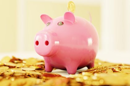 pink pig coin bank on brown wooden table; sinking fund