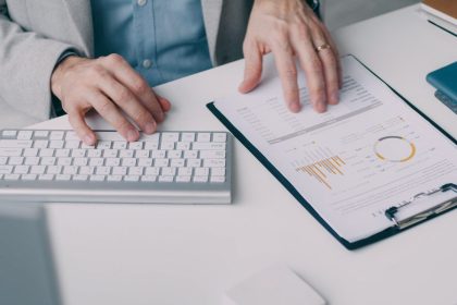 A man sitting at a desk working on a computer; how to read a credit report