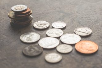 coins on gray surface; student loan wage garnishment; student loan wage garnishment