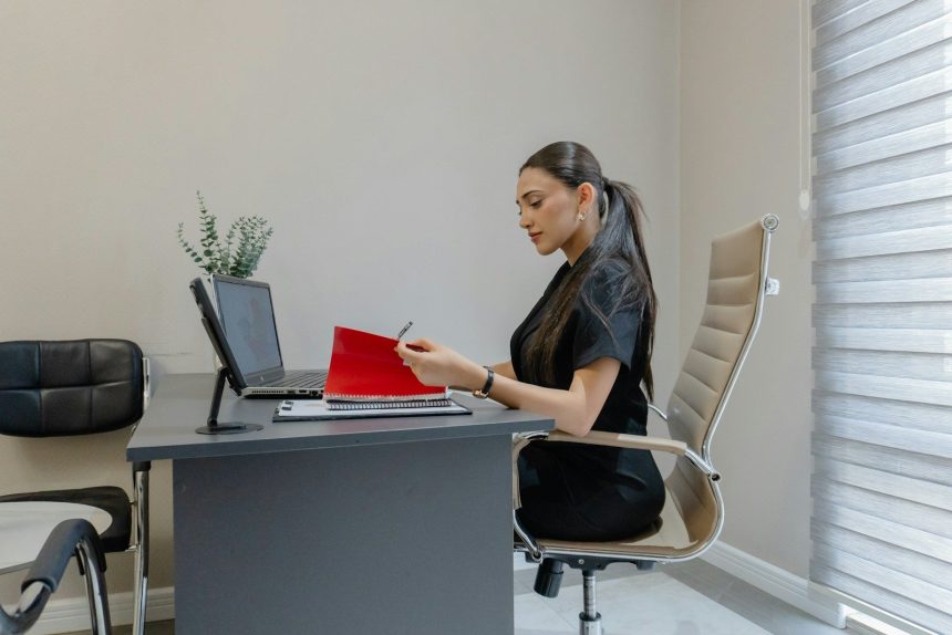 Woman working at a desk with a laptop and laptop.; public service loan forgiveness