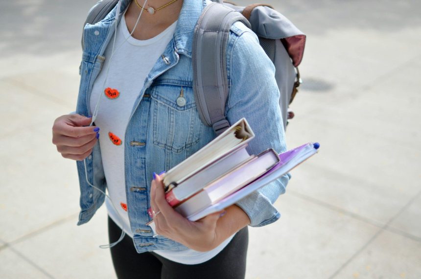 woman wearing blue denim jacket holding book; SAVE plan