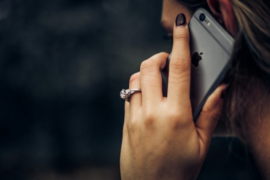 woman talking on the phone; debt relief or credit repair scam