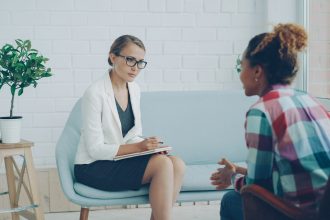 Two women talking in a therapy session; dual diagnosis treatment
