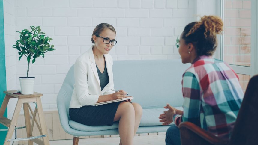 Two women talking in a therapy session; dual diagnosis treatment