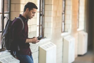 man leaning while holding leather wallet; PSLF payment count