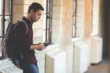 man leaning while holding leather wallet; PSLF payment count