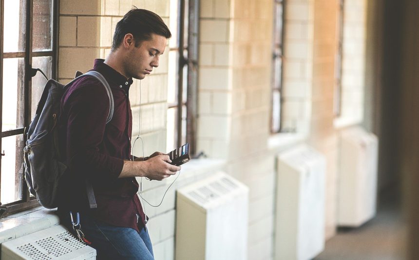 man leaning while holding leather wallet; PSLF payment count