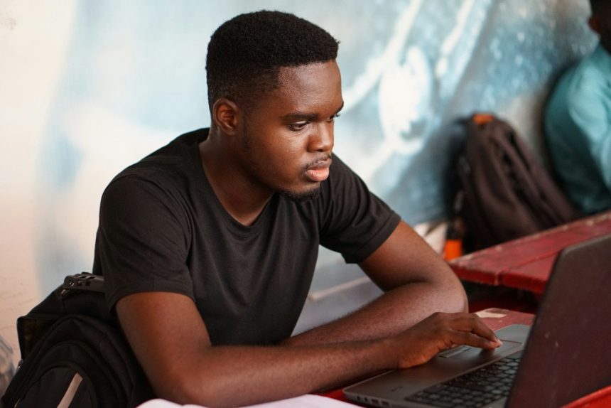 man in gray crew neck t-shirt using laptop computer; second wave of student loan