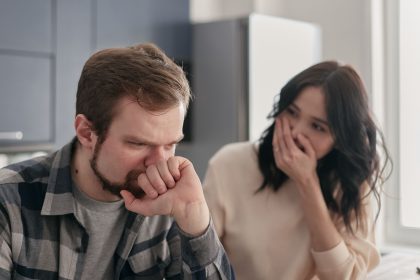 Anxious couple talking seriously about financial regret and debt in 2026