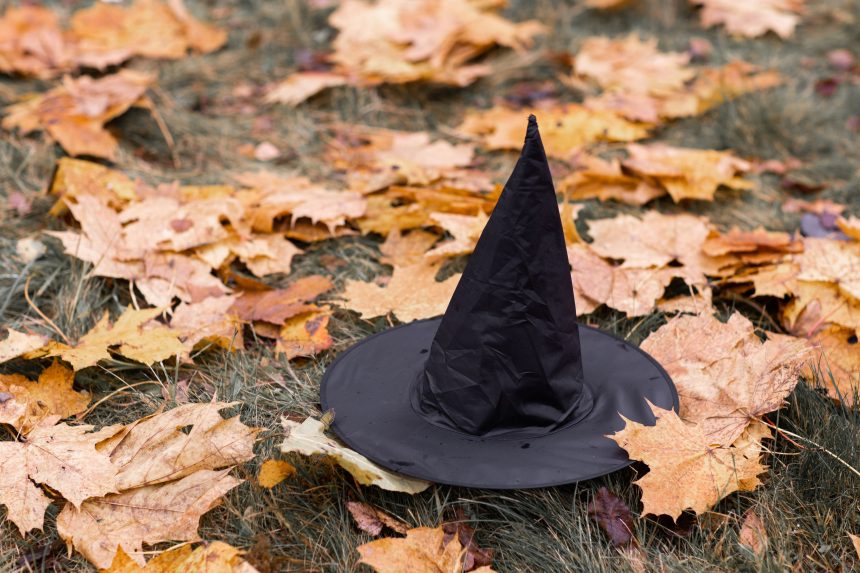 Witch hat on fallen autumn leaves representing the rise in Halloween spending debt in 2026