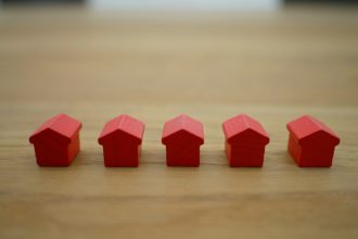 red blocks on brown wooden table; rent debt