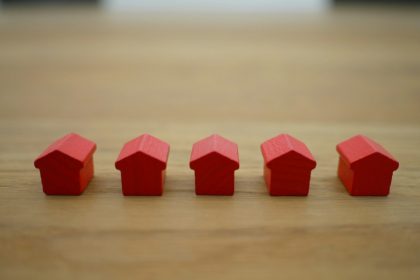 red blocks on brown wooden table; rent debt