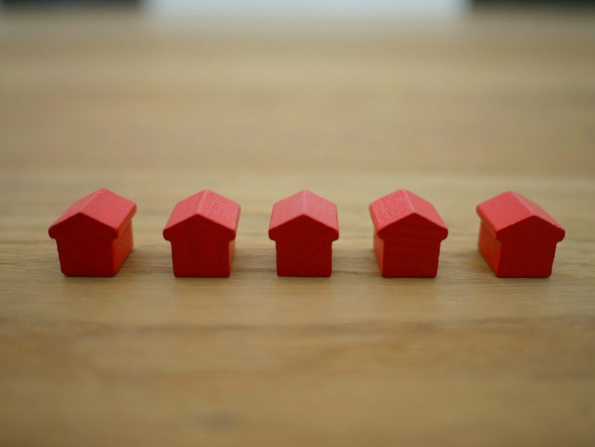 red blocks on brown wooden table; rent debt