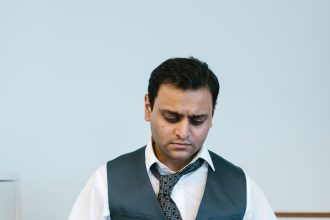 Man packing a box after a layoff, reflecting how layoffs and debt are rising together in 2026