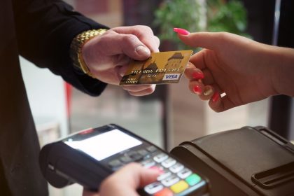 Close-up of a credit card payment at a checkout terminal, reflecting more Americans relying on credit cards in 2026
